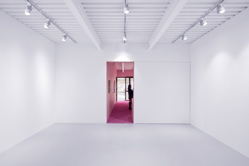 White-walled gallery with overhead lighting by Golem