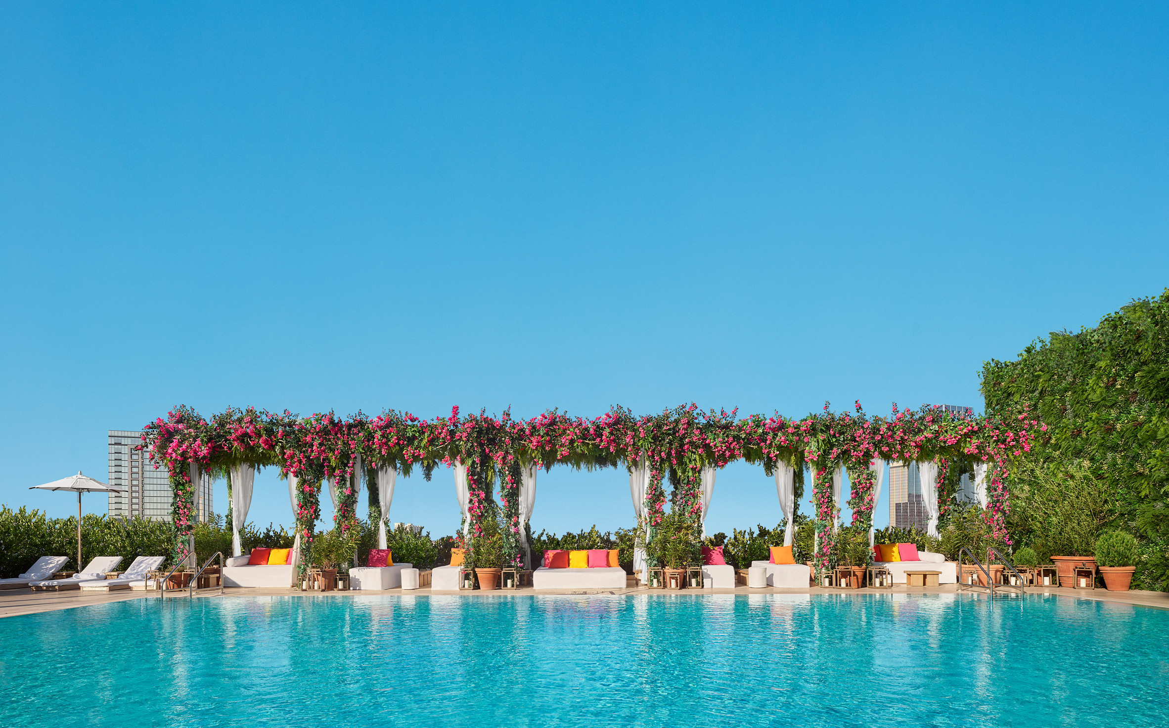 Pool terrace with flower-covered cabanas