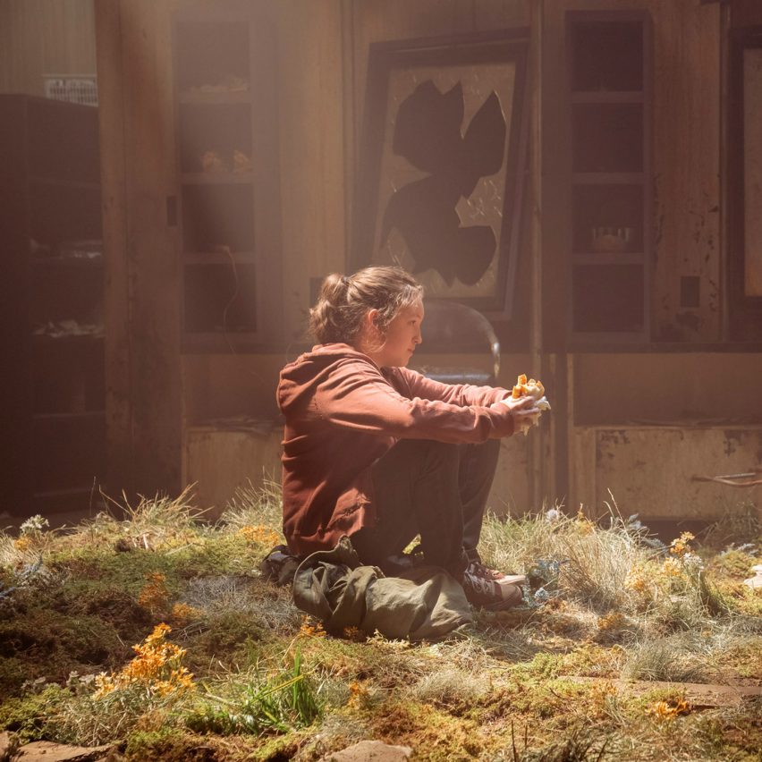 Ellie sitting on an overgrown floor in The Last of Us