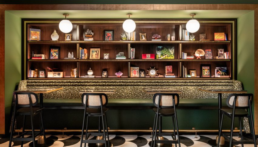 A banquette beneath bookshelves at The Lymbar