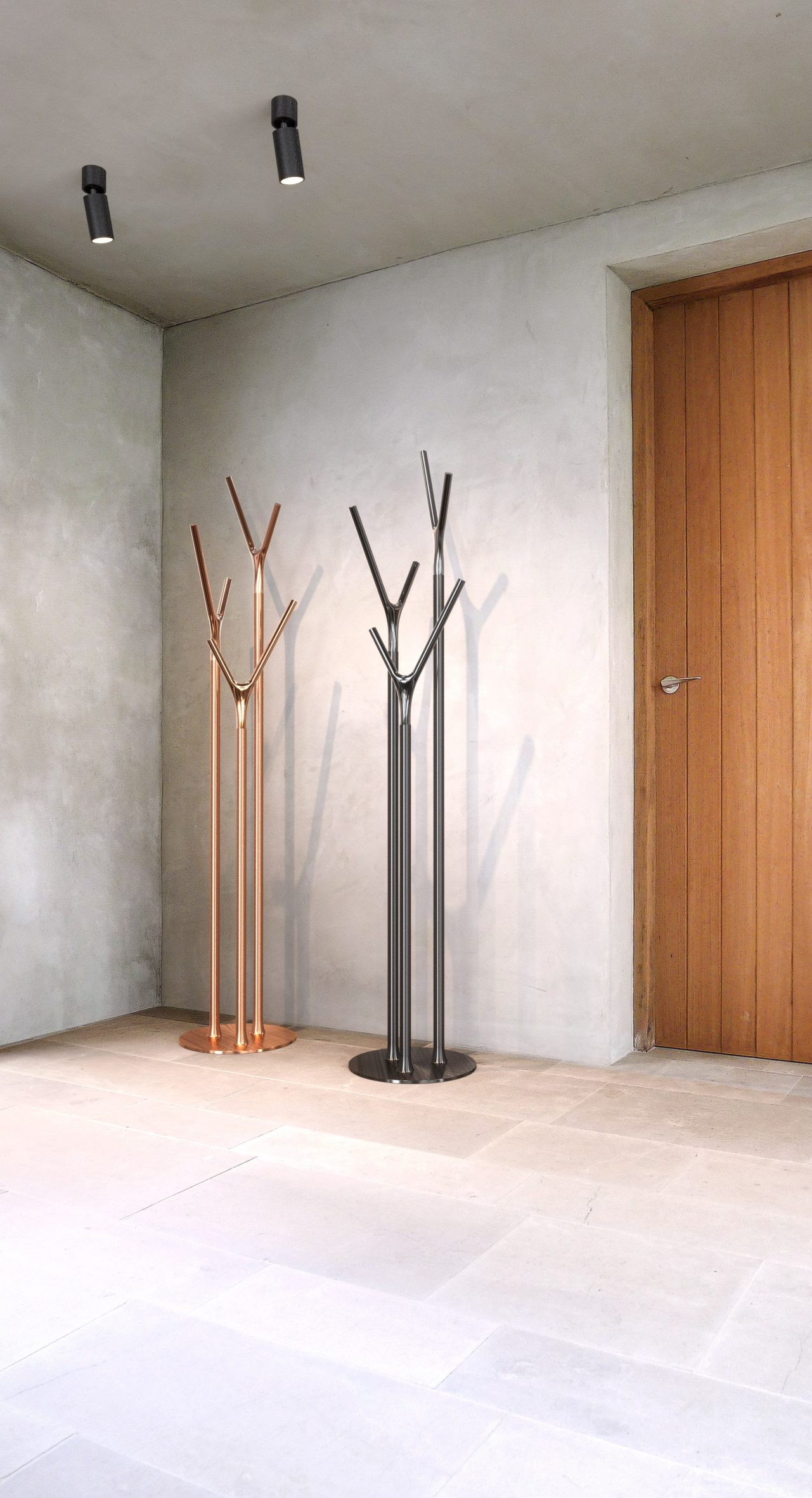 Photo of two Wishbone hall stands in copper and black colours in the corner of a room