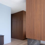 Home interior with wooden flooring and walls covered with walnut wall panelling