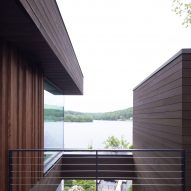Elevated outdoor terrace overlooking a lake with an opening over a courtyard below