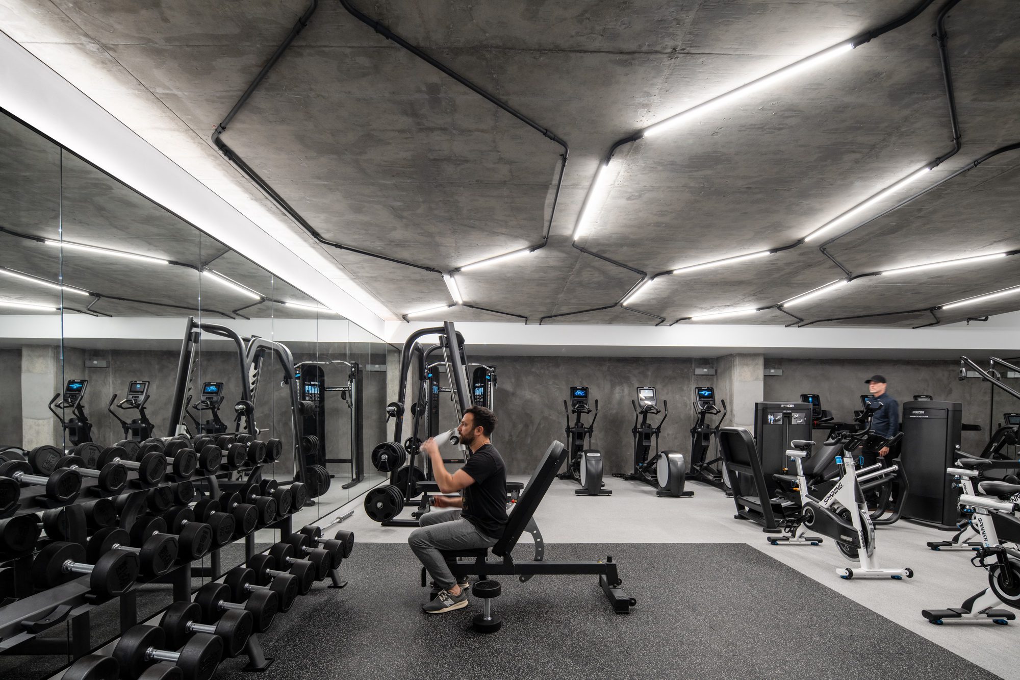 Fitness centre with honeycomb lighting overhead