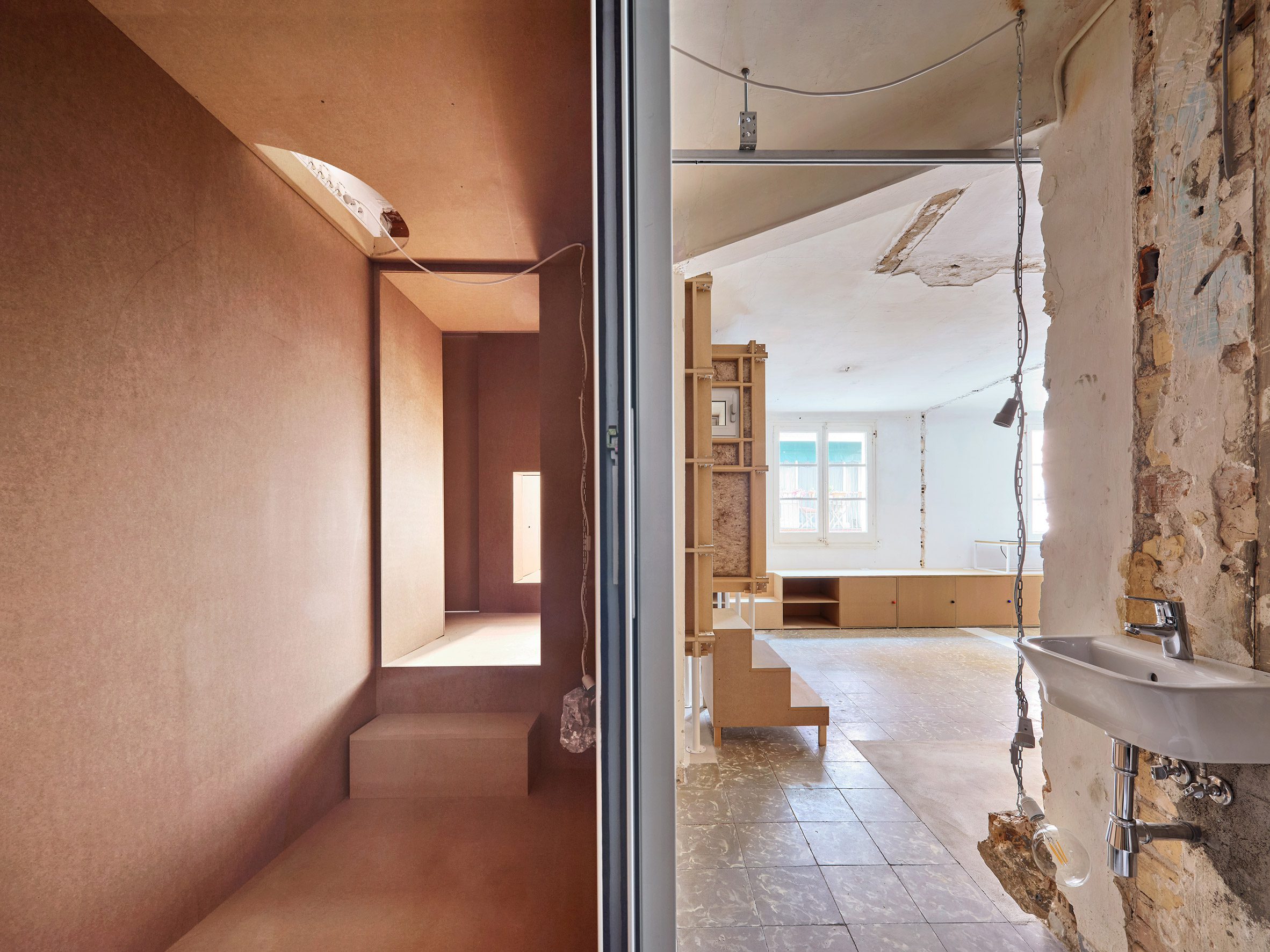 MDF walls and raw fixtures within apartment in Barcelona