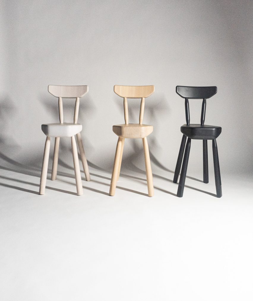 Three wooden chairs in natural, white and black stain finishes by Ca'lyah