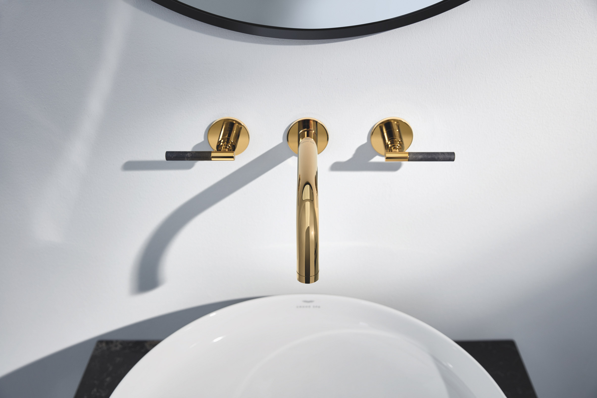 Gold coloured mixer tap above sink