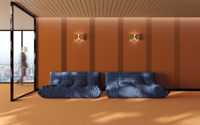 Wall of acoustic panels with sofas lined up against them