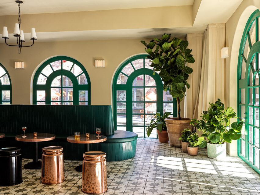 Bar area illuminated by green-framed arched windows