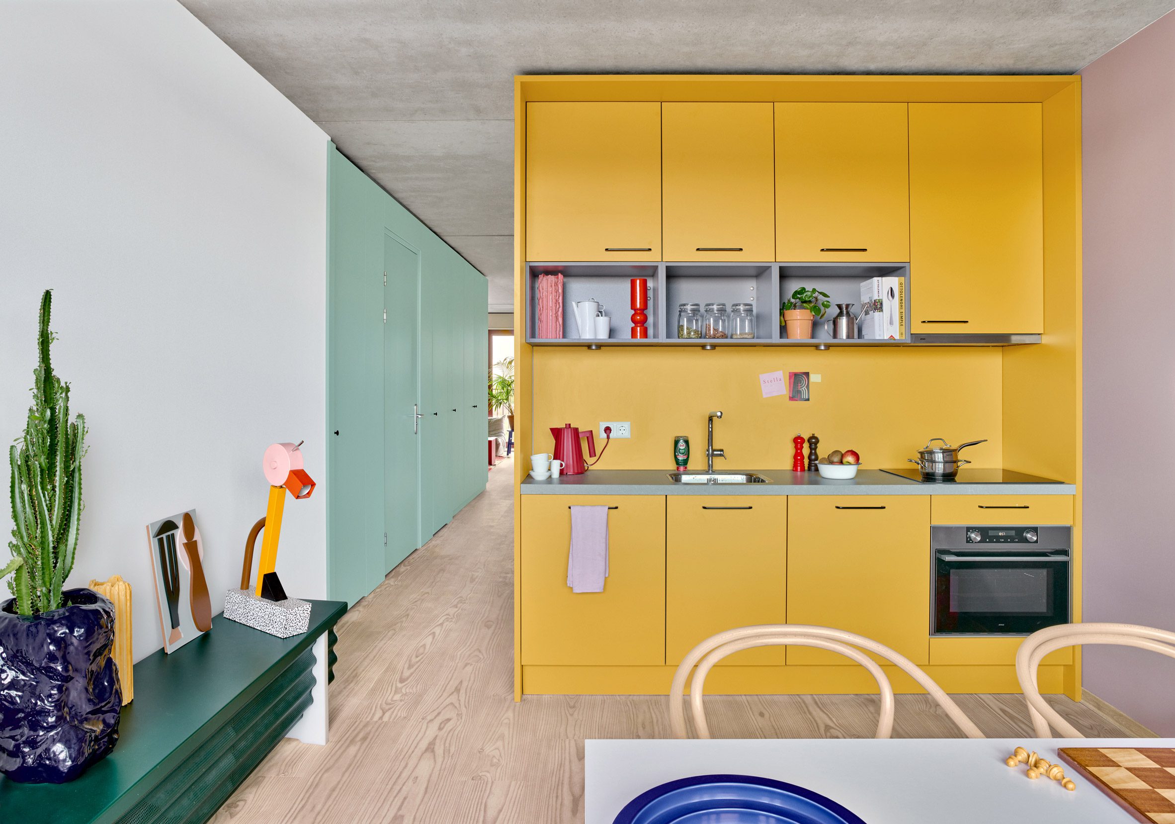 Bright yellow modular kitchen in compact apartment