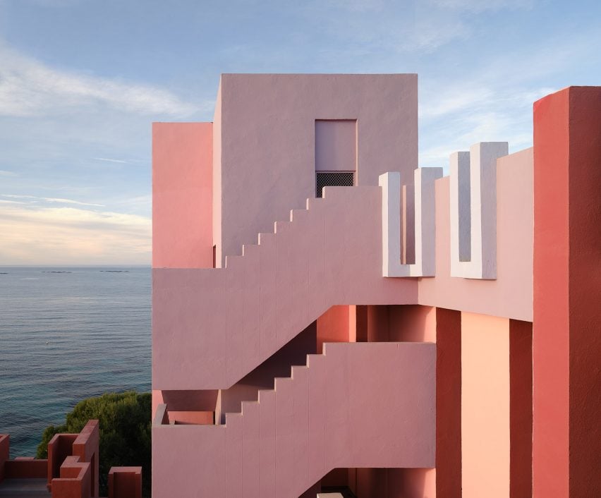 Muralla Roja pink inset stair with sea in the background