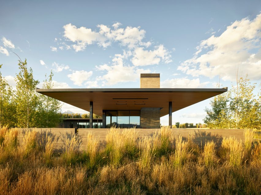 Wild grasses flanking low-slung home at Black Fox Ranch in Wyoming