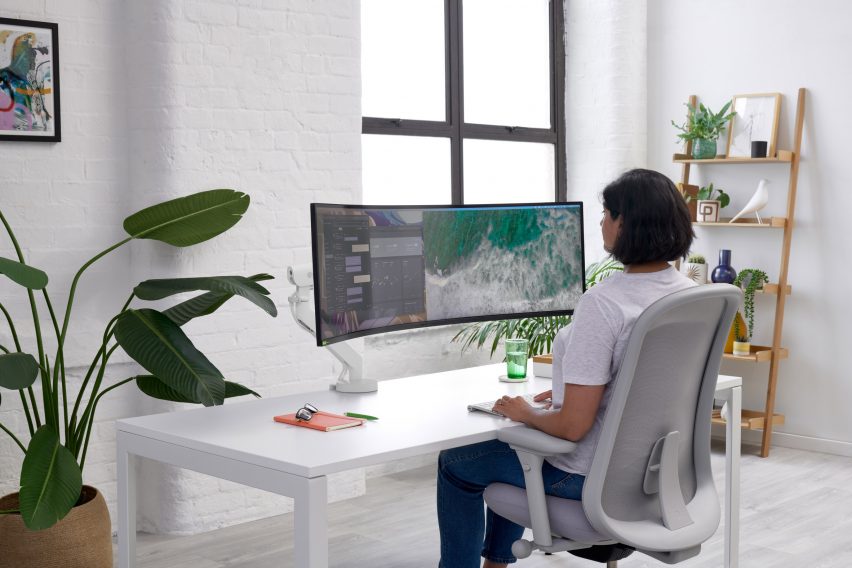 Black curved screen supported by monitor arm
