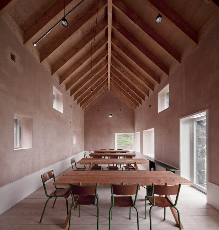 Gabled roof with pine rafters and suspended black pendant lights within Croft 3 restaurant