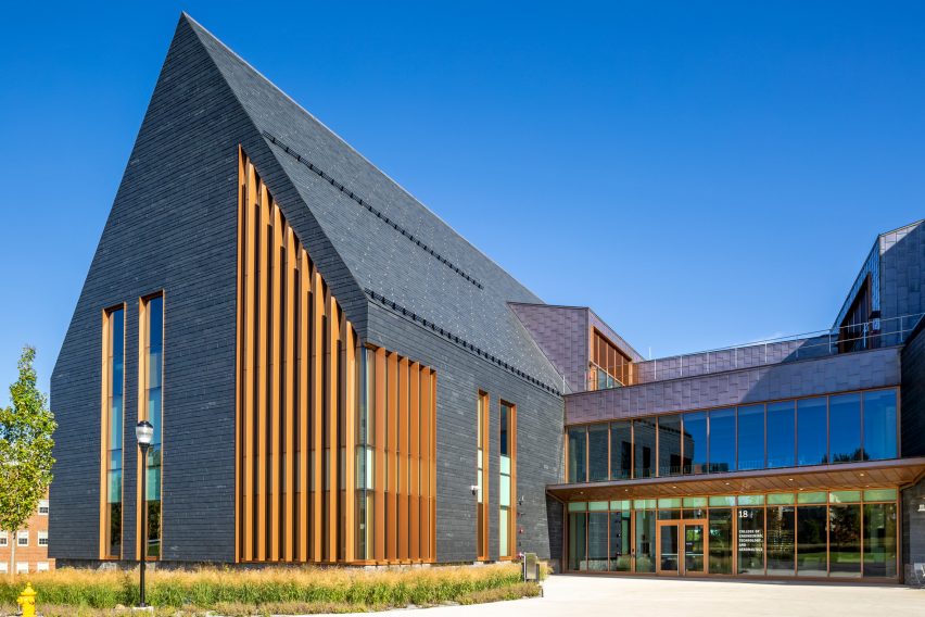 Slate-clad building with a steep-pitched roof and wood louvres