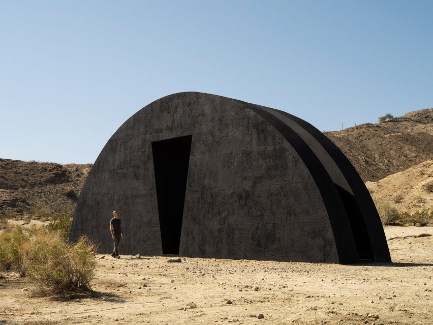 Black semicircular desert installation