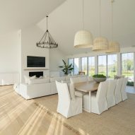 Open-plan living room with timber floors and white walls