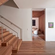 Interior entryway with white walls, oak flooring and oak staircase