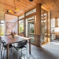 Open-plan kitchen and dining room with wood ceiling and table