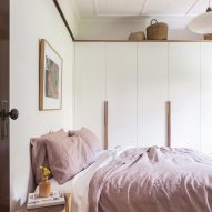 Bedroom with white walls, wood flooring and double bed with pink bedding