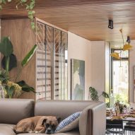 Living room with taupe sofa and wood flooring and ceiling