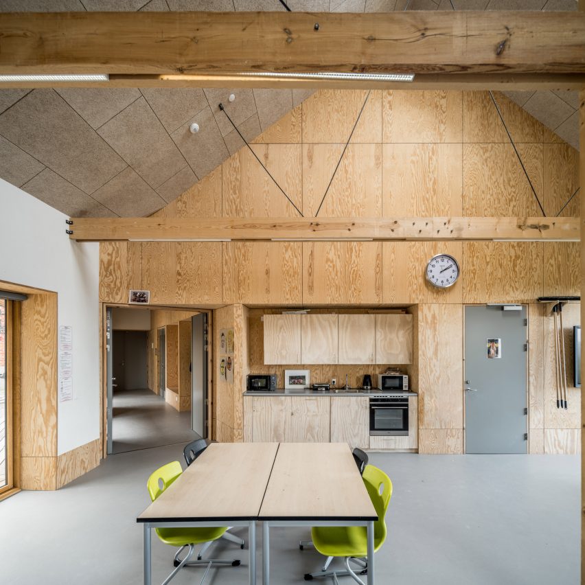 Interior del aula con paredes de madera.