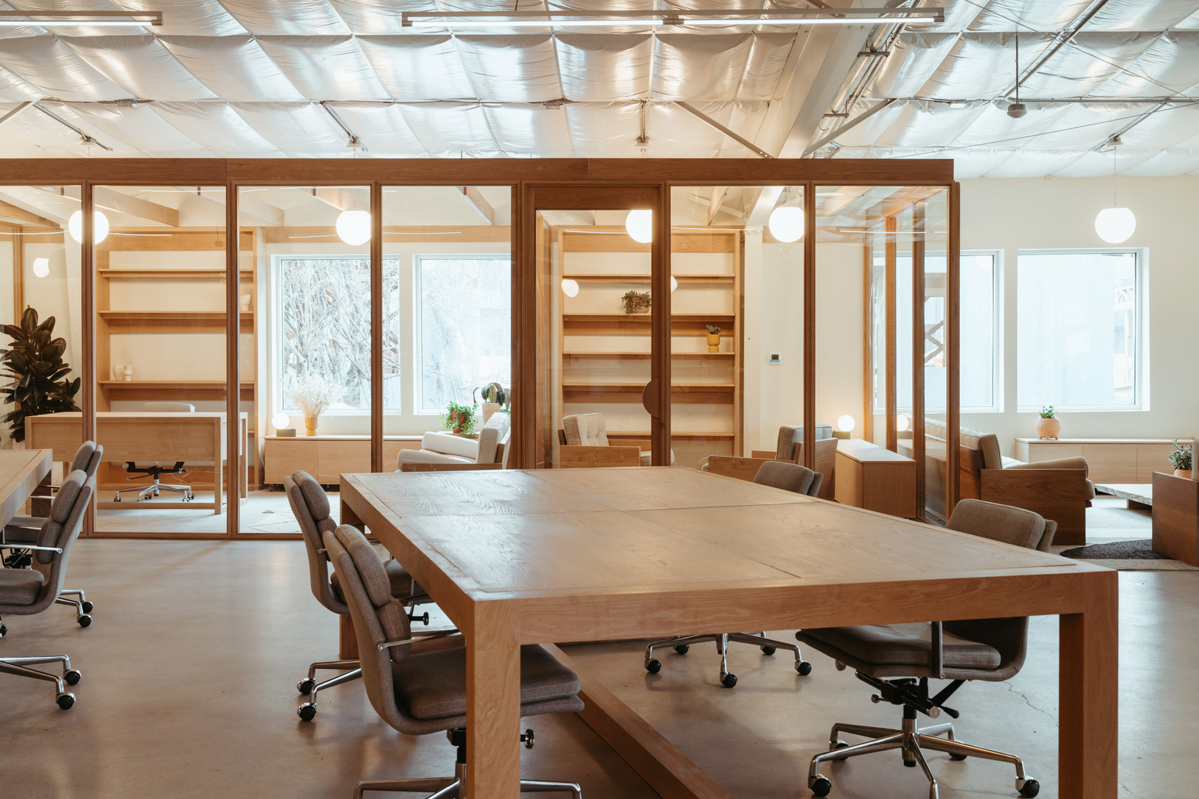 Open workspace featuring large wood tables