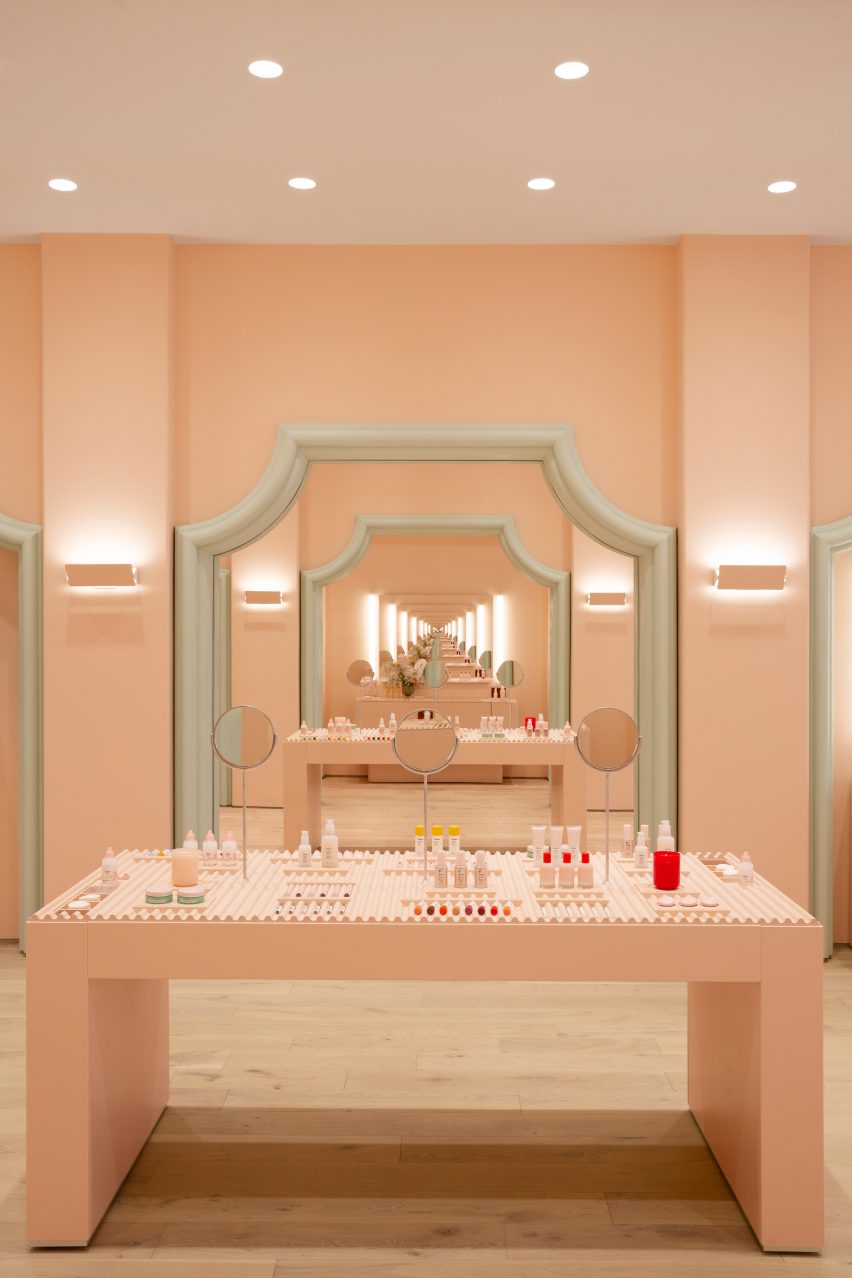 Infinite mirror reflections in pale pink Glossier store