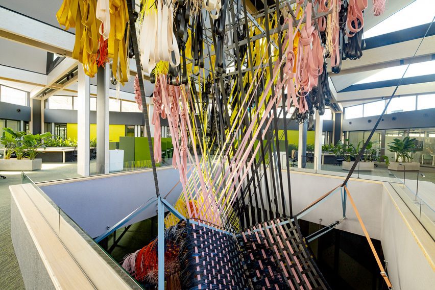 Multi-coloured Loom Room woven installation suspended in an atrium