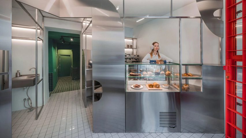Bakery interior with steel counters and white tiled floors