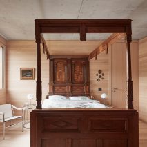 Four-poster bed in house designed by Bernardo Bader