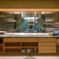 Restaurant kitchen with built-in wood furniture and terrazzo flooring