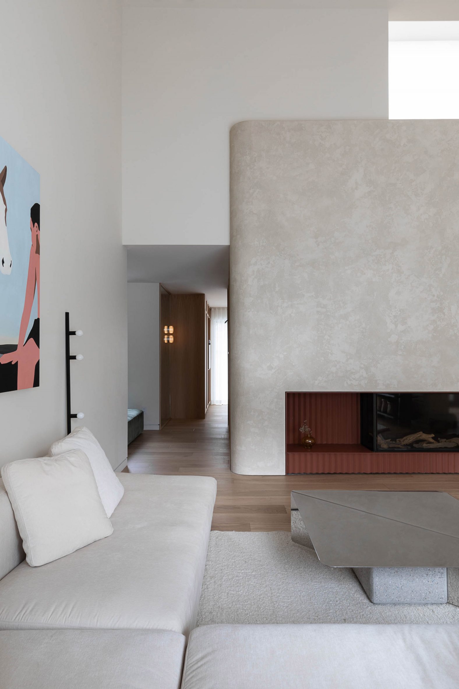 Rounded plaster details and a terracotta fireplace within house in Canada