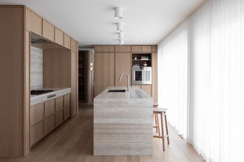 Travertine island within kitchen in Montreal home