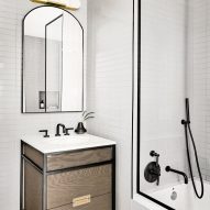 Bathroom with a wood vanity, decorative tiled floors and white walls
