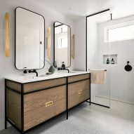 White bathroom with a wooden double vanity and walk-in shower