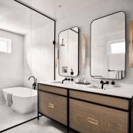 White bathroom with a wooden double vanity and walk-in wet room