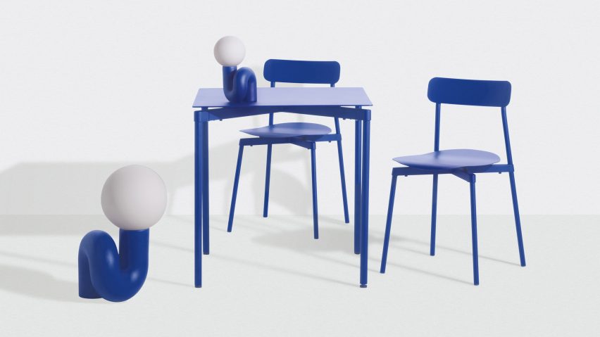 Two blue Neotenic lamps by Jumbo NYC for Petite Friture posed around a matching blue table and chairs