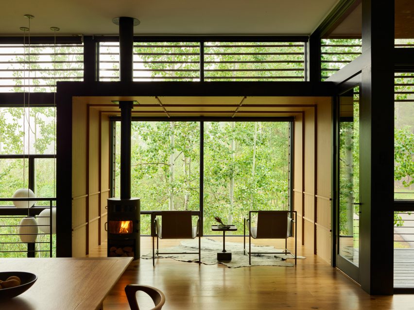 Seating area in front of large window overlooking trees