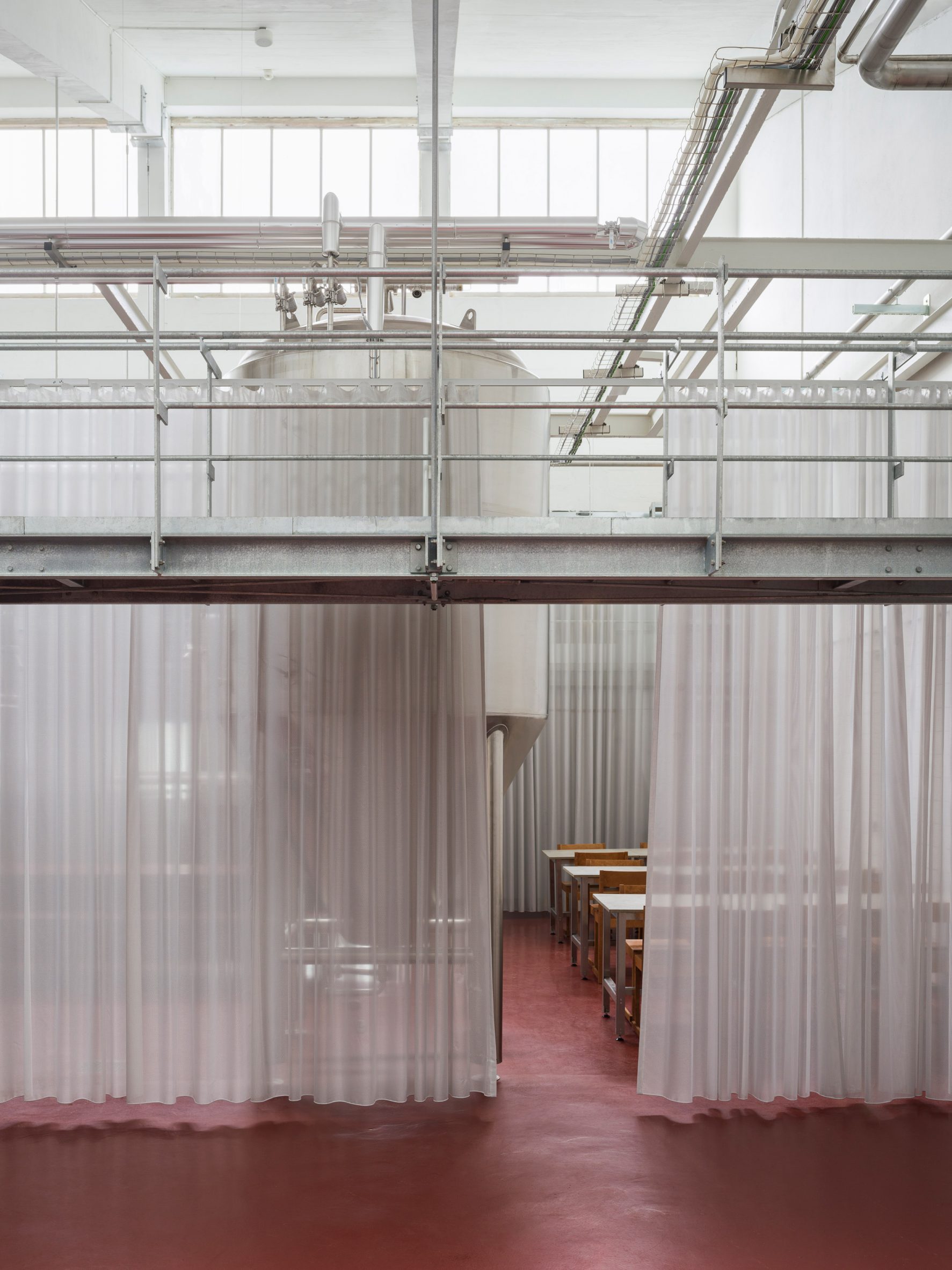 Semitransparent curtains within brewery designed by Pihlmann Architects