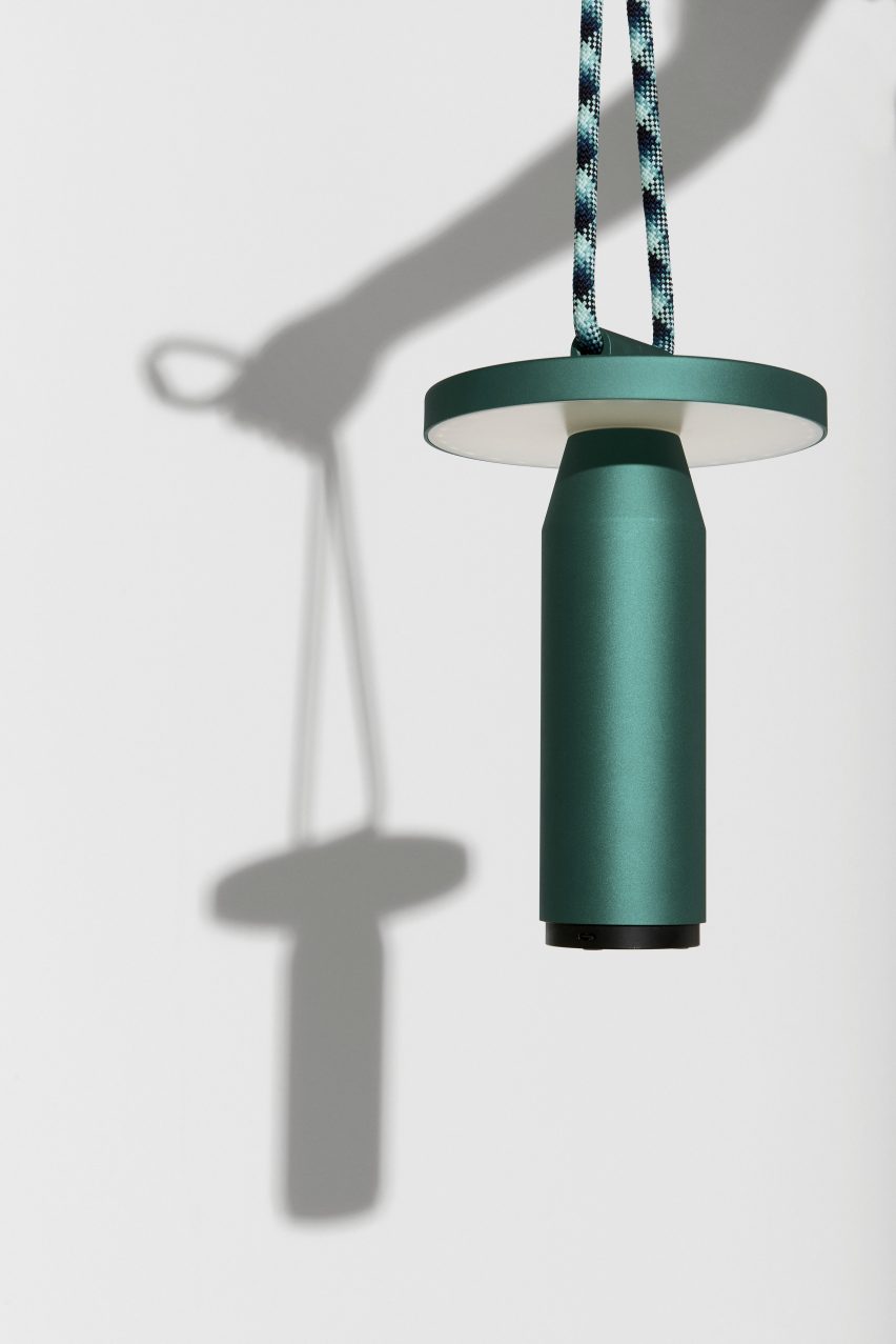 Arm holding a green Quasar lamp by Samy Rio for Petite Friture