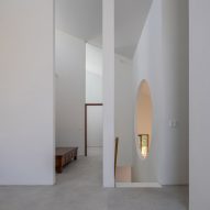Interior space with concrete flooring, white walls and tall door openings