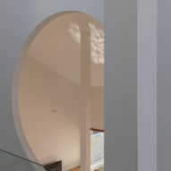 A circular window in a white wall
