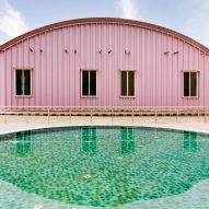 Pink steel shed in front of a swimming pool