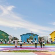 Colourful amphitheatre surrounded by green, blue and yellow steel buildings