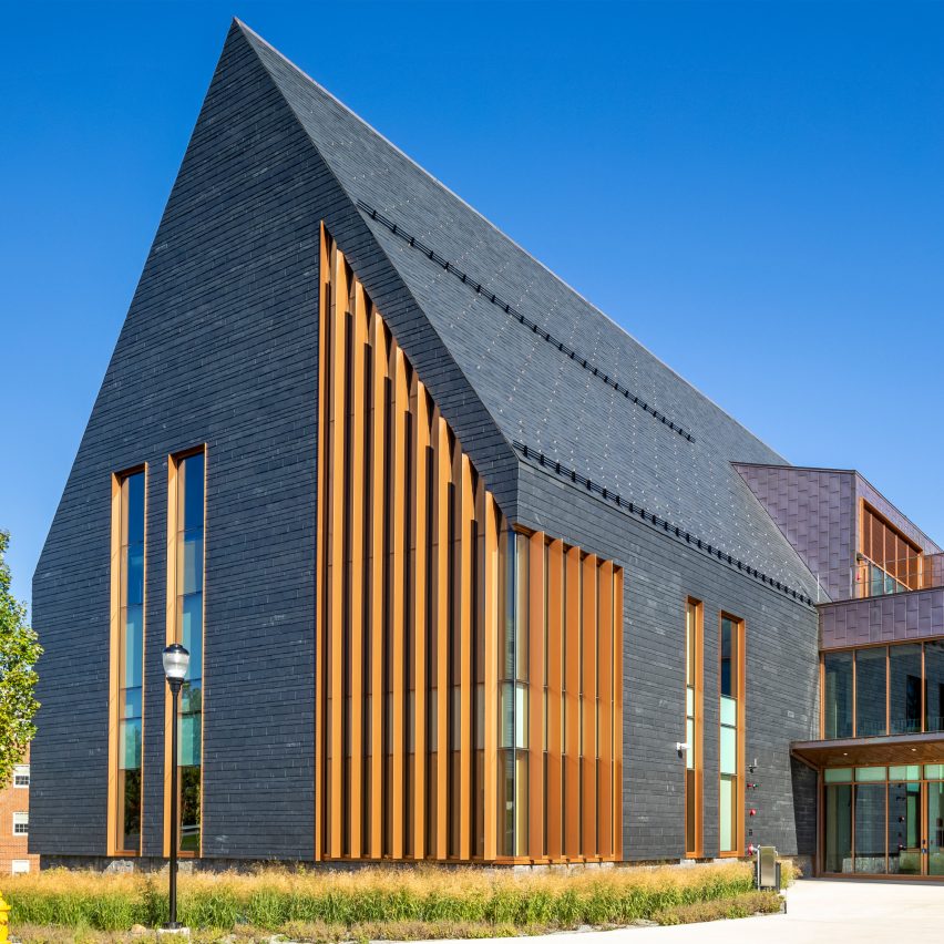 Slate-clad building with a steep-pitched roof and wood louvres