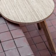 Table balanced on step with two front legs over edge