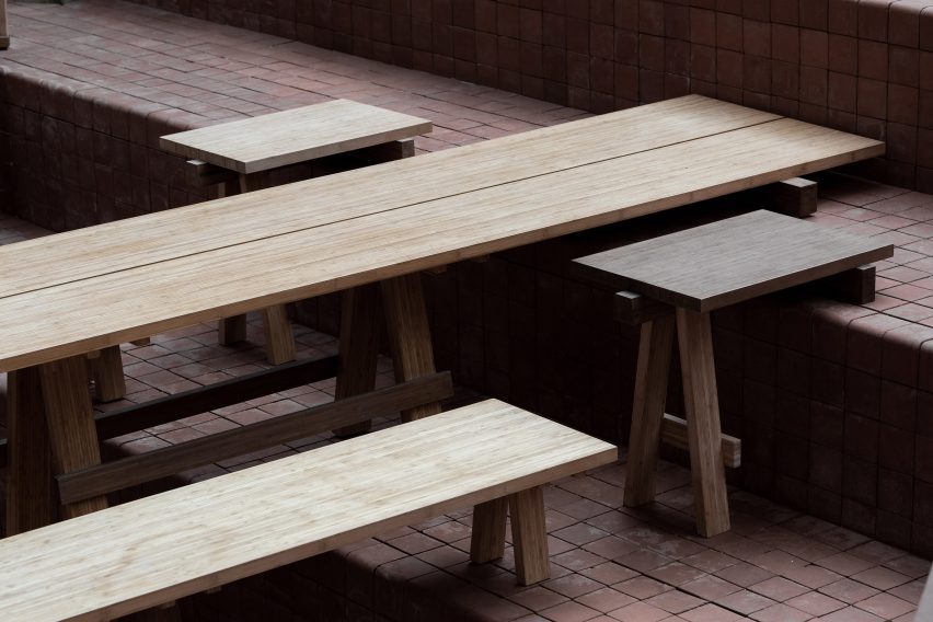 Benches and table balanced on step with two front legs