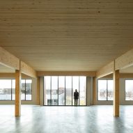 Interior of an empty office space with concrete floor and timber ceiling and structure