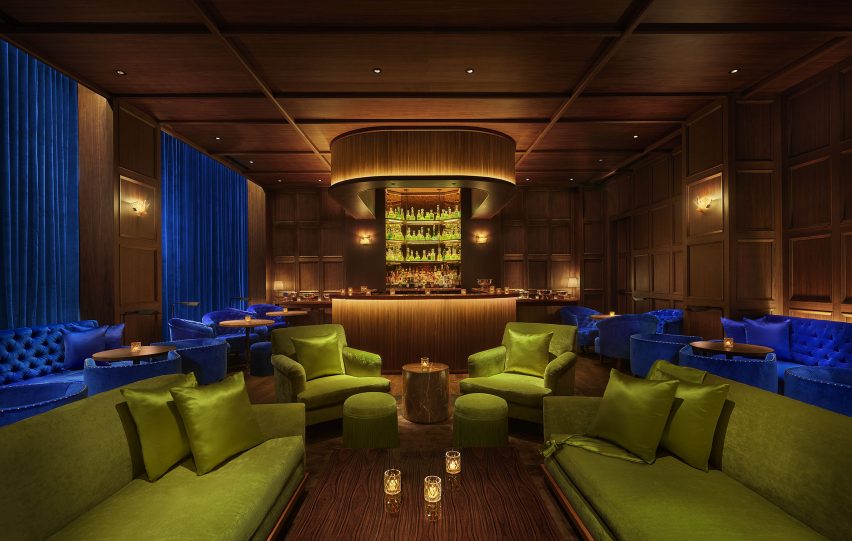 The Punch Room features walnut panelling and jewel-toned sofas